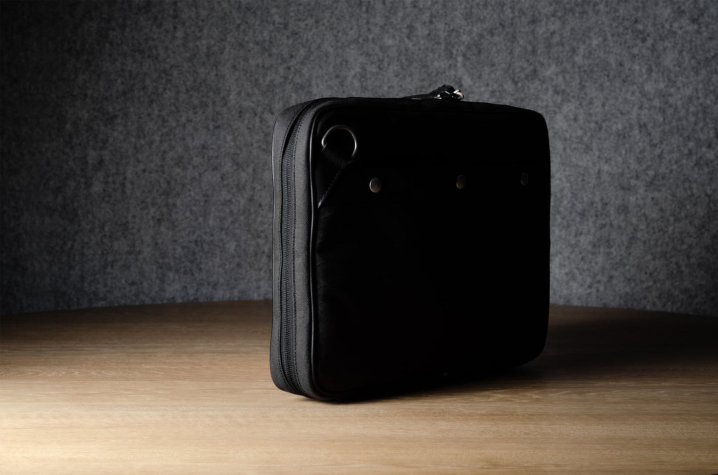 A suitable laptop bag. Charcoal gray.